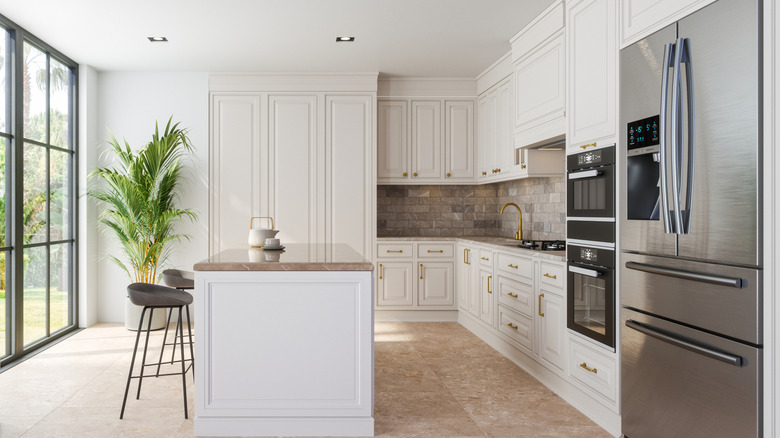 A modern kitchen with large windows, letting in lots of natural light