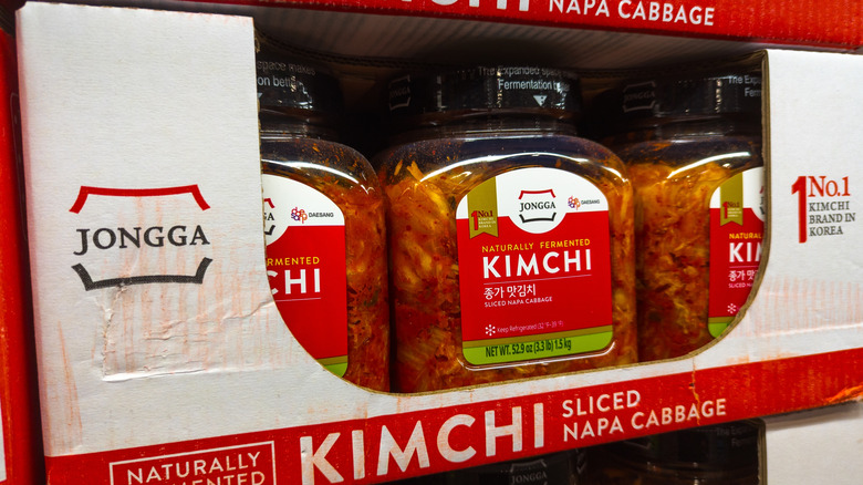 Containers of kimchi sit in their shipping packaging at a Costco