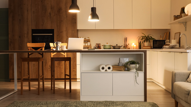Kitchen with rug, furniture, and ambient lighting