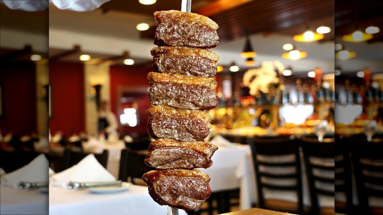 diners being served churrasco
