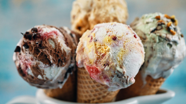 Four scoops of ice cream in sugar cones