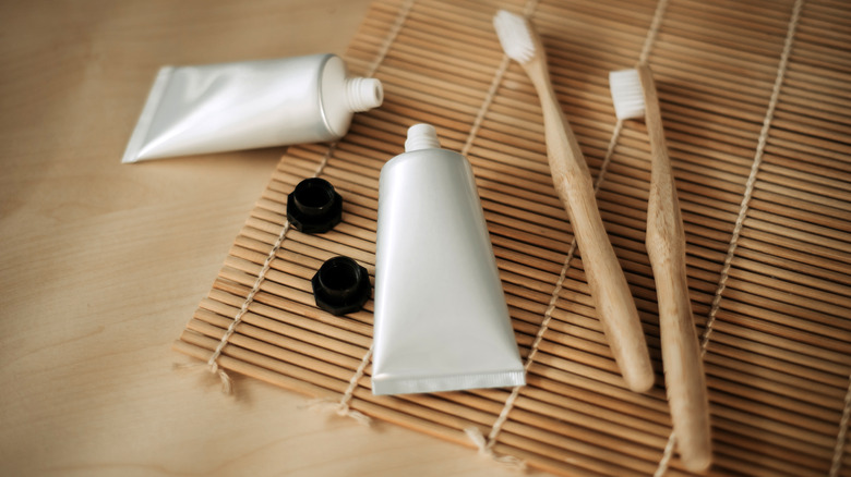 Toothbrushes and toothpastes on mat