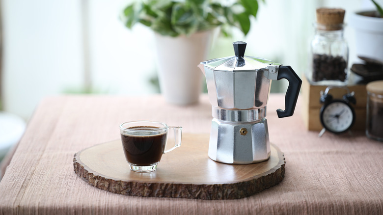 Moka pot and cup of coffee