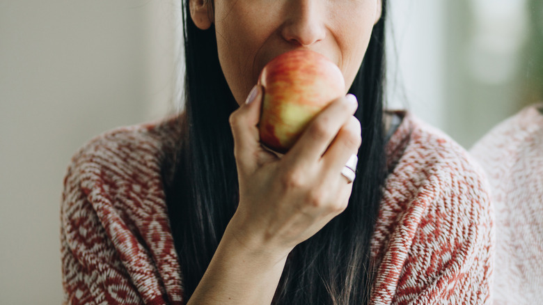 Woman eating an apple