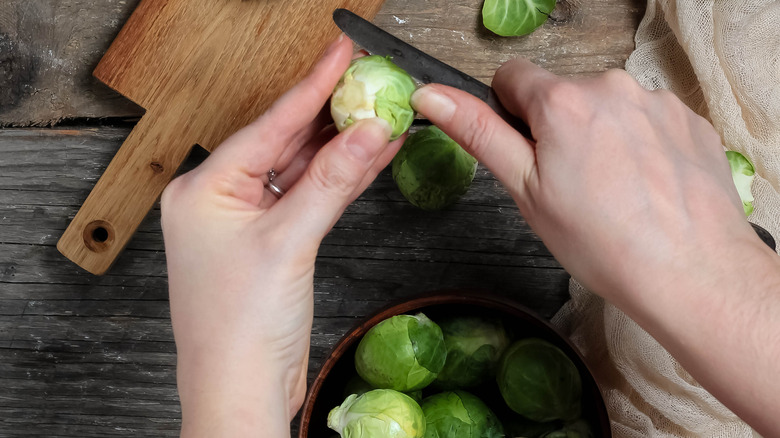 hands trimming brussels sprouts