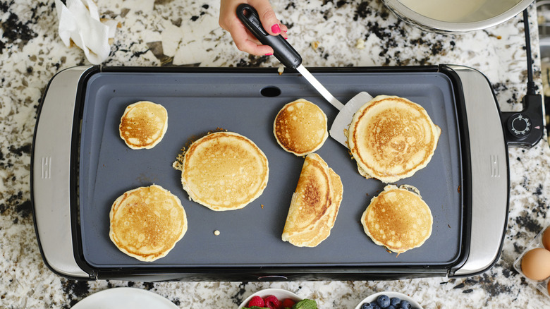Pancakes cooking on an electric griddle
