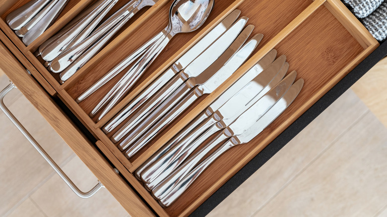 Silverware sits in a separator inside a kitchen drawer