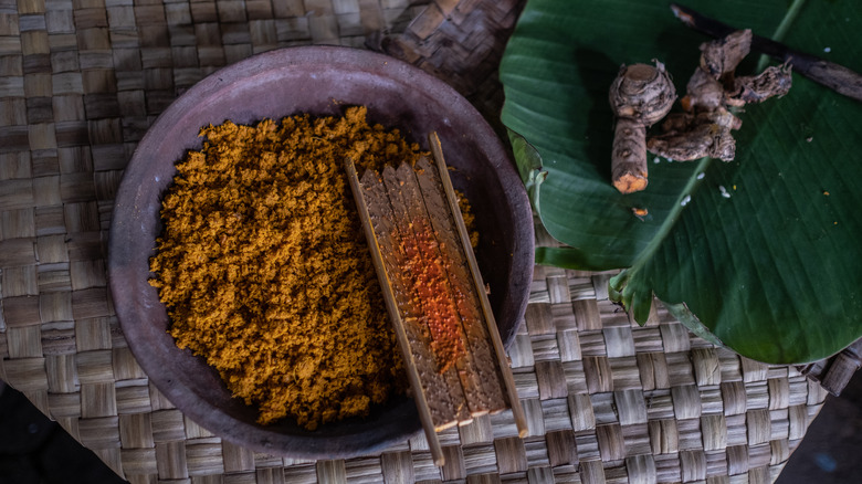 Turmeric in dish and grater