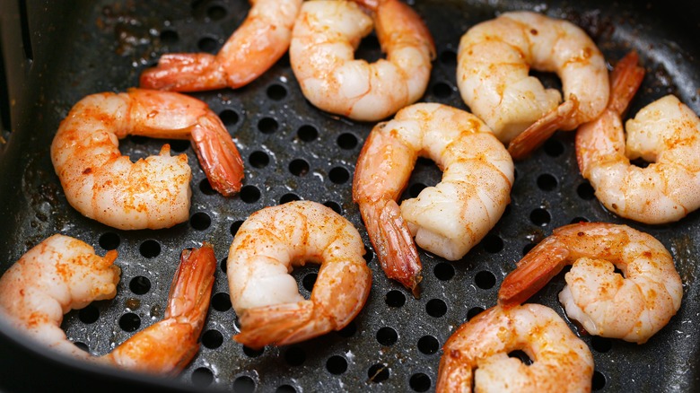 Shrimp cooking in an air fryer.