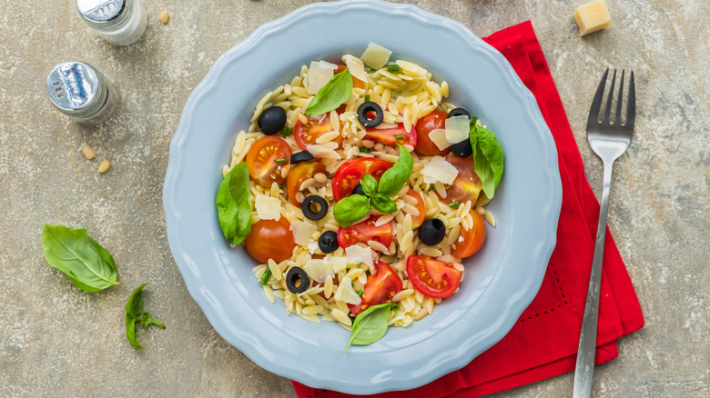 Orzo pasta salad with tomatoes, basil, and olives