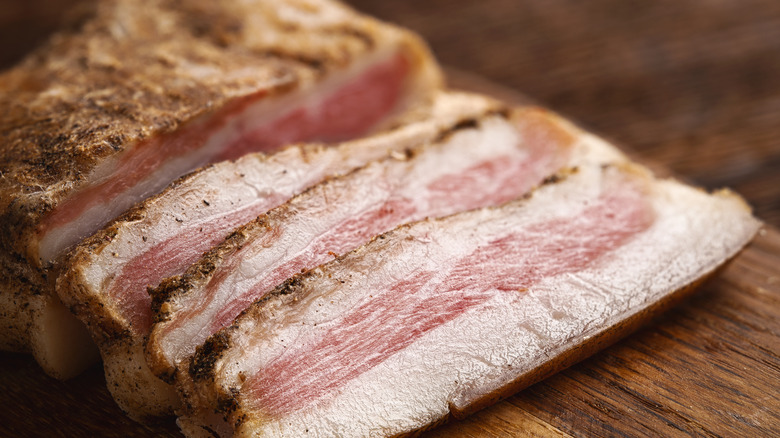 sliced pork jowl on a cutting board