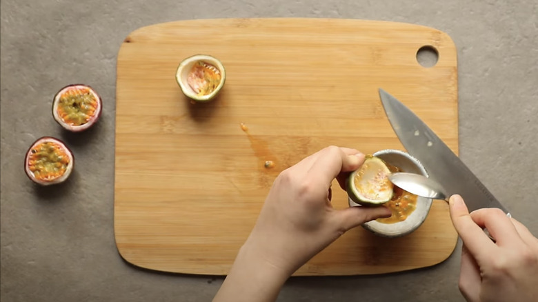 Scooping passion fruit with spoon