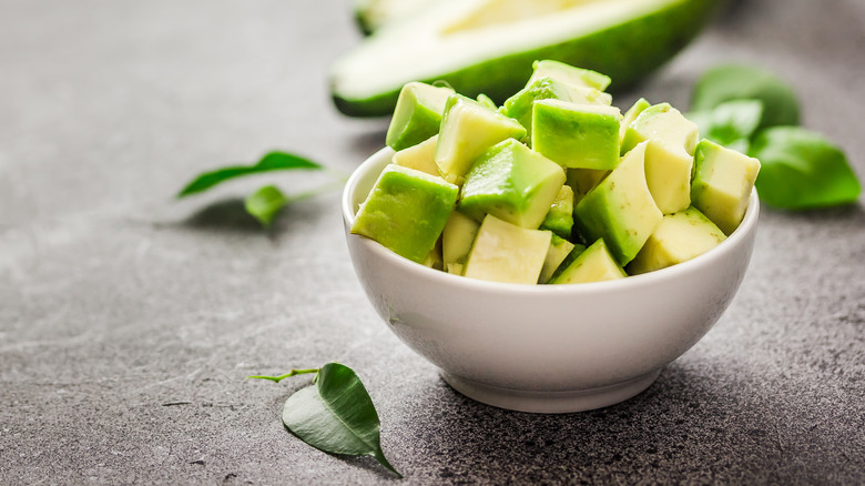 Small white bowl with dices cubes of avocado