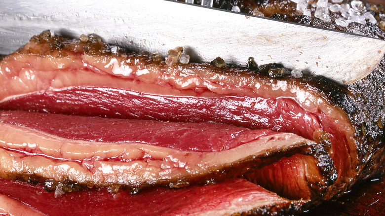 Knife slicing through steak