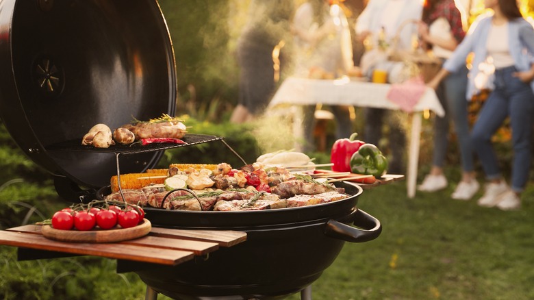 Open grill with lots of food cooking