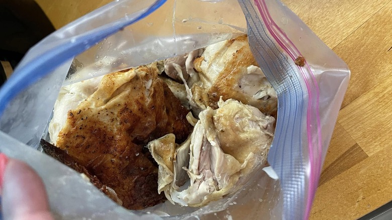 Rotisserie chicken in a plastic zip-top bag