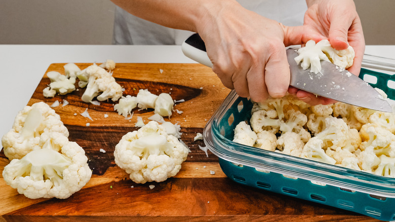 Person chopping cauliflower