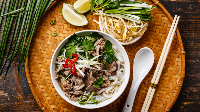 bowl of beef pho on tray