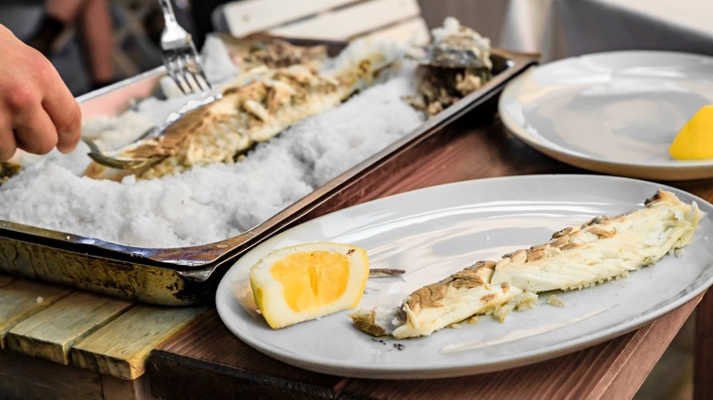 Removing portions of whole cooked fish