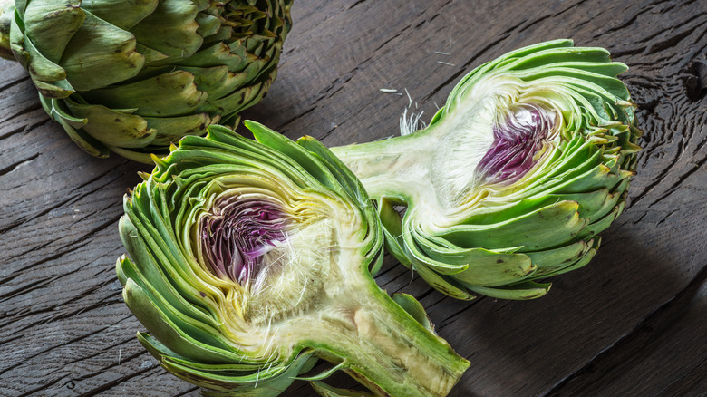 Artichoke cut open on wooden board