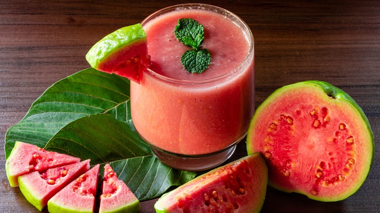 Sliced guavas with a glass of guava juice