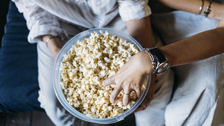 Two people eating popcorn