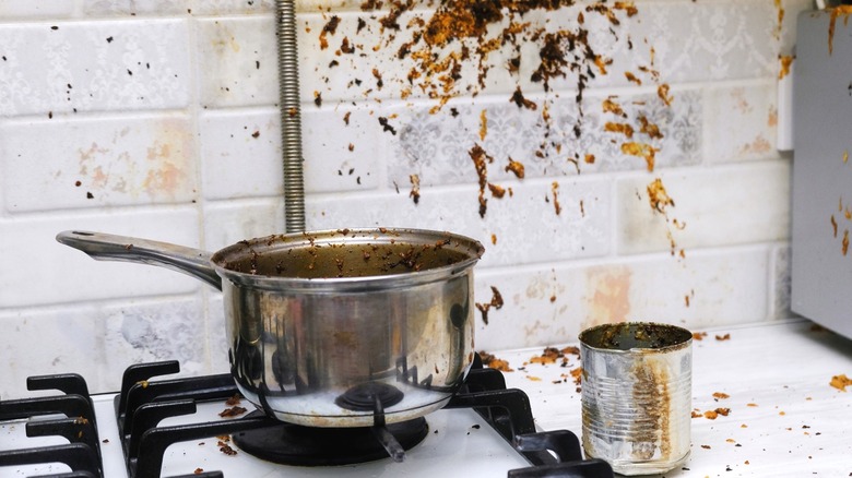 dirty pot on stove and kitchen wall splatter