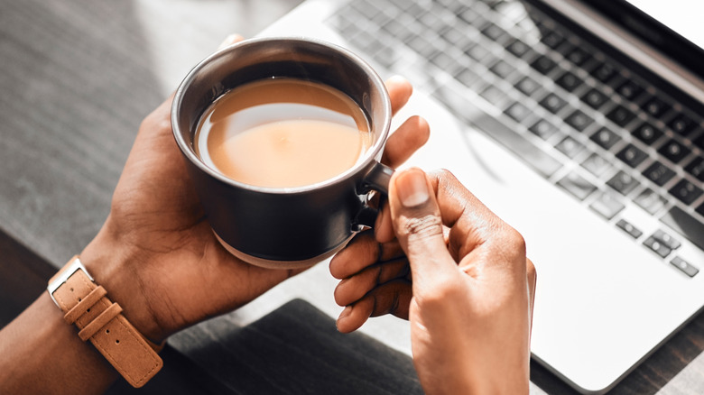 Hands holding cup of coffee