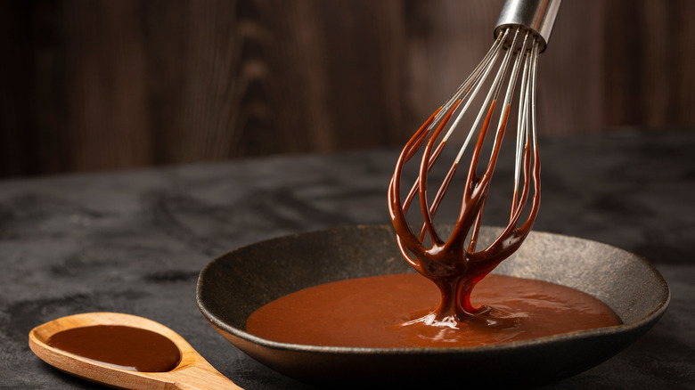 melted chocolate in a bowl with whisk