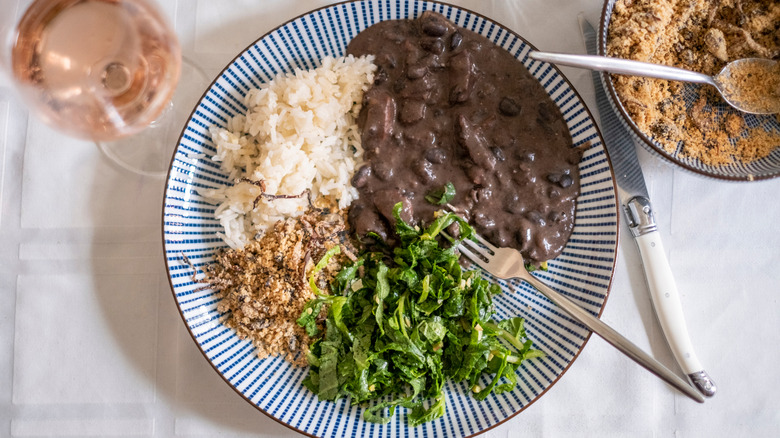 Brazilian feijoada and farofa with collard greens