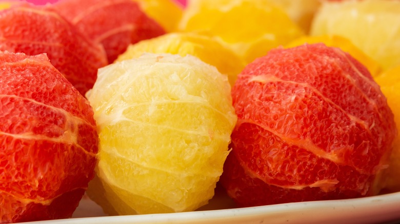 Peeled oro blanco and red grapefruits