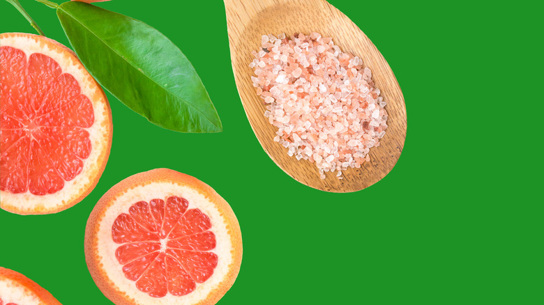 Sliced grapefruit and spoon of salt