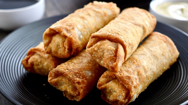 fried egg rolls on a black plate