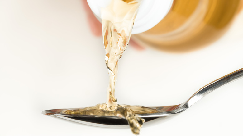 Vinegar being poured onto a spoon.