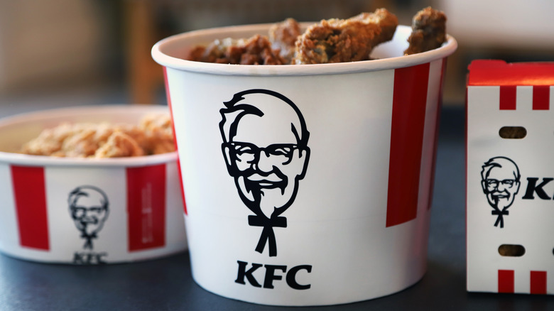 Several buckets of KFC fried chicken.