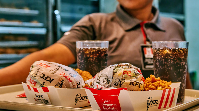A KFC employee with a meal.