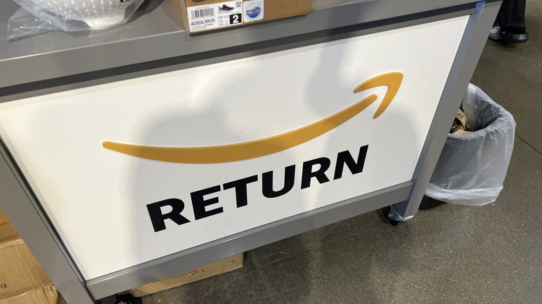 An Amazon return sign fronts a cart at a Whole Foods store