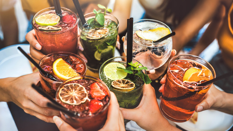 Cheerful cocktail toasting by a group of friends.