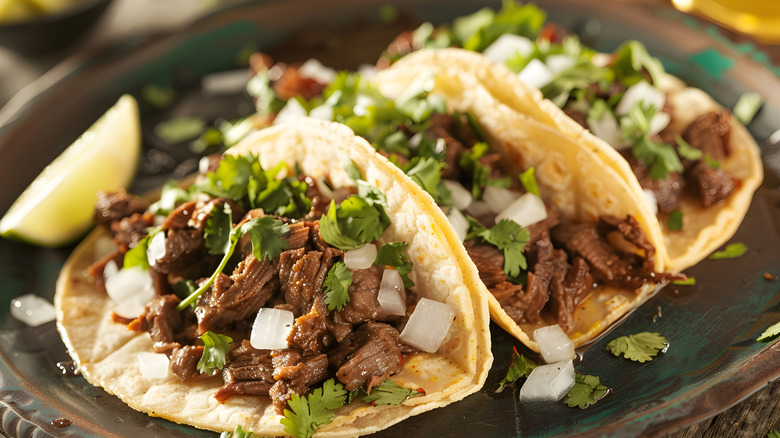 shredded chuck roast tacos with cilantro and white onions