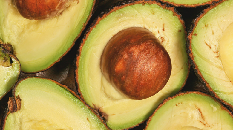 Avocado halves, with the brown seed visible inside.