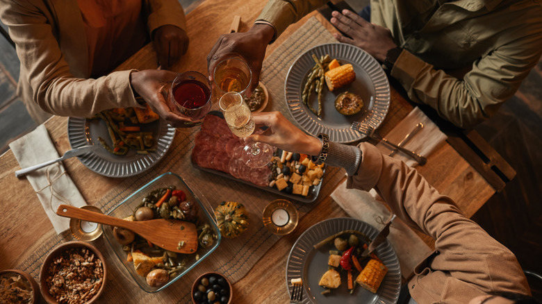 people toasting at dinner party table