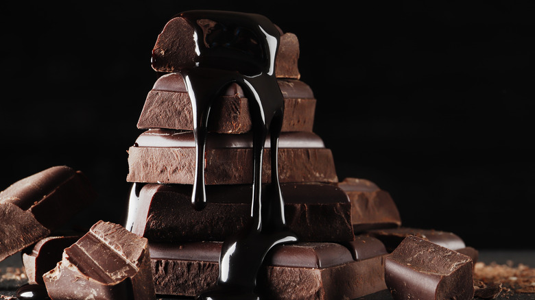melted chocolate pouring onto chocolate pieces
