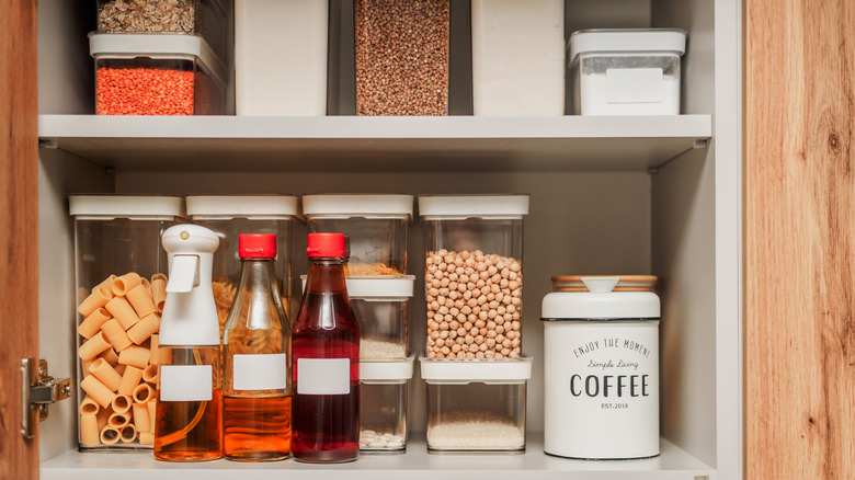 A cupboard organized with matching containers