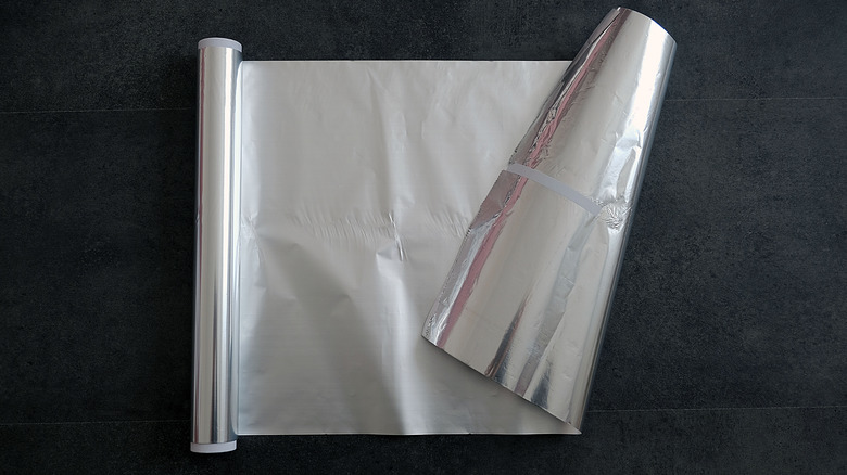 Roll of aluminum foil on dark surface