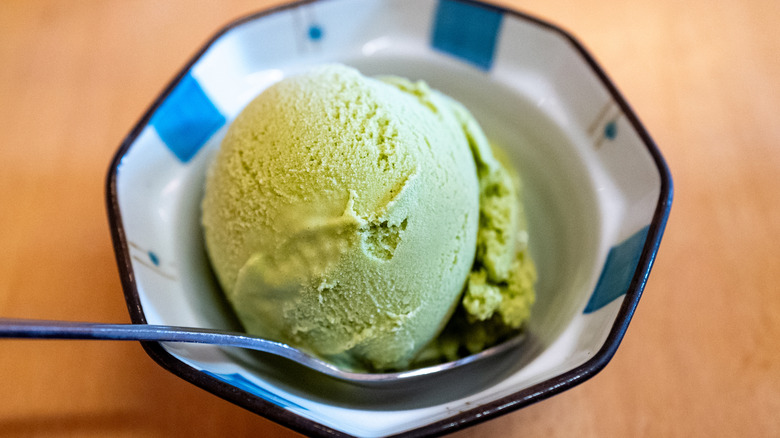Green ice cream in a bowl with a spoon
