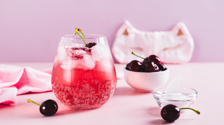 A pink fizzy drink crafted with cherries.