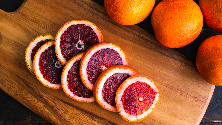 Blood orange sliced on cutting board.