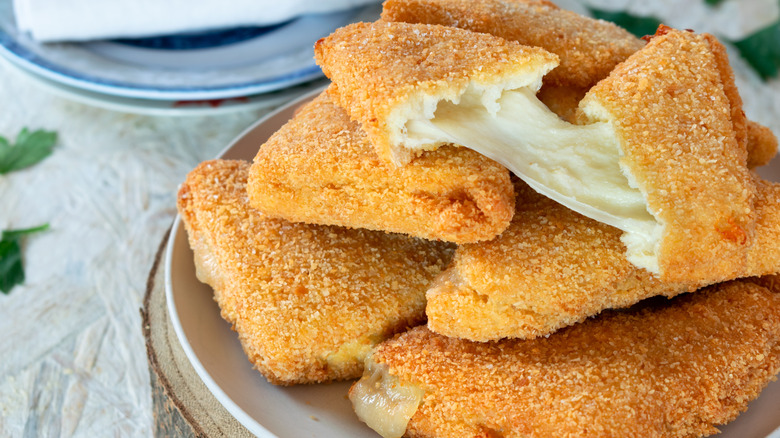 cheesy gooey mozzarella in carrozza piled on a plate
