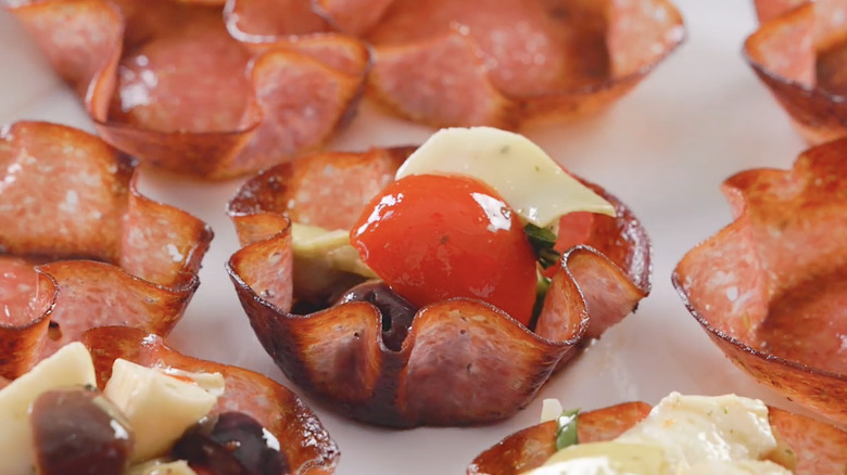 Crispy salami cups filled with antipasto ingredients.