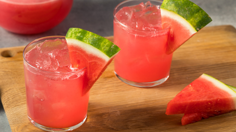 Watermelon cocktails next to watermelon slices.